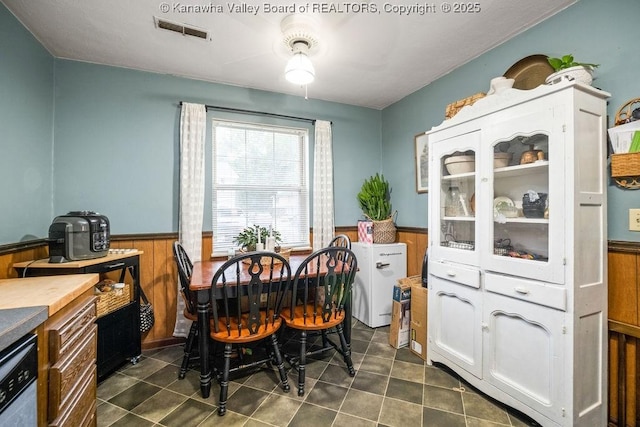 dining room featuring wooden walls