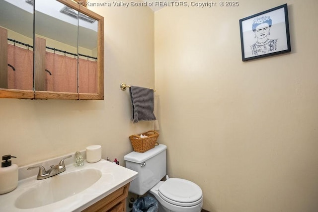 bathroom with vanity and toilet