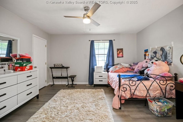 bedroom with ceiling fan and dark wood-type flooring