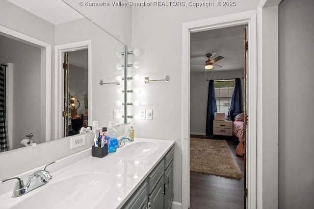 bathroom featuring hardwood / wood-style flooring, vanity, and ceiling fan