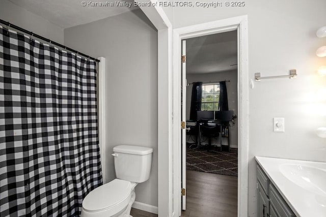 bathroom with hardwood / wood-style floors, vanity, and toilet