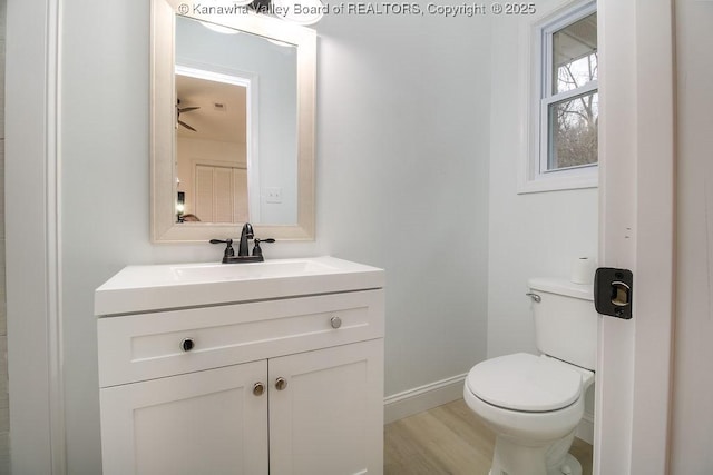 bathroom featuring hardwood / wood-style floors, vanity, and toilet