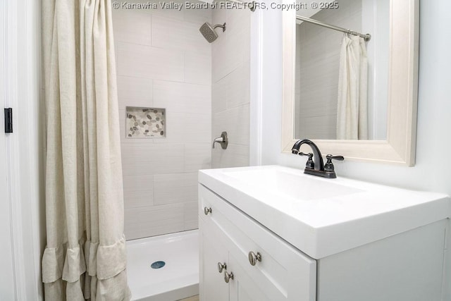 bathroom featuring curtained shower and vanity