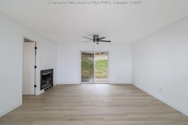 unfurnished living room with ceiling fan and light wood-type flooring