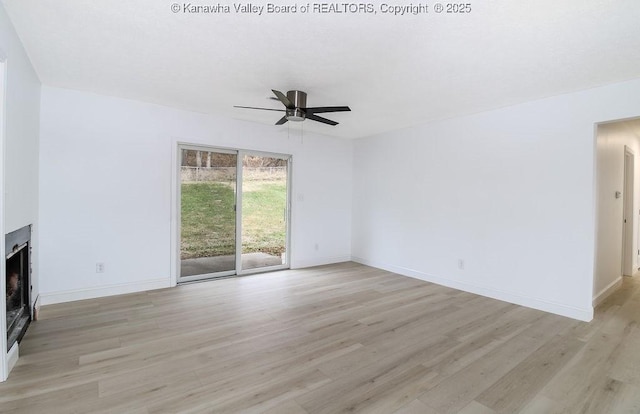 unfurnished living room featuring ceiling fan and light hardwood / wood-style floors