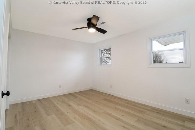 empty room with light wood-type flooring, ceiling fan, and a healthy amount of sunlight