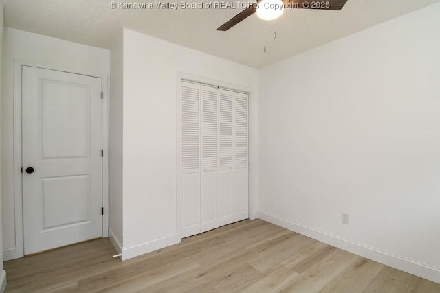 unfurnished bedroom with a closet, light hardwood / wood-style flooring, and ceiling fan