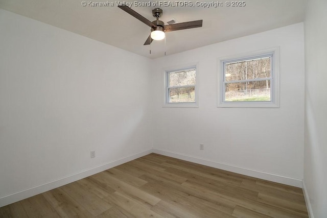 spare room featuring light hardwood / wood-style floors and ceiling fan