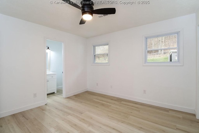 unfurnished bedroom with connected bathroom, ceiling fan, light hardwood / wood-style flooring, and multiple windows