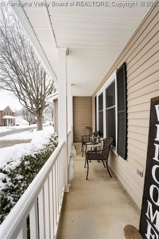 view of snow covered back of property