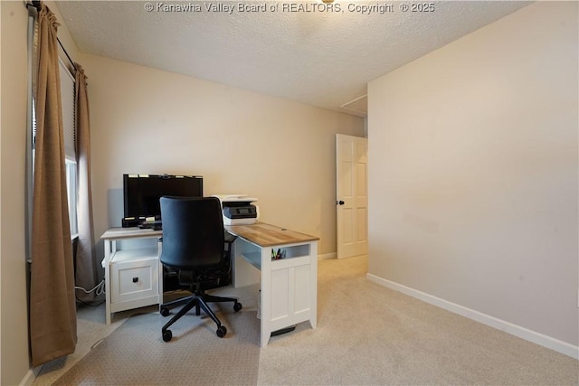 carpeted home office with a textured ceiling