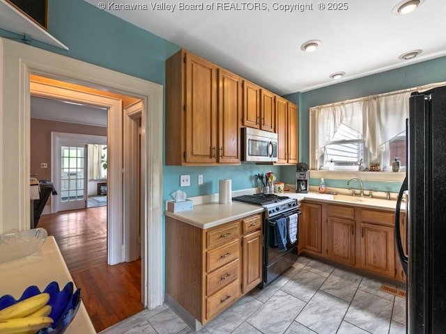 kitchen with sink and black appliances