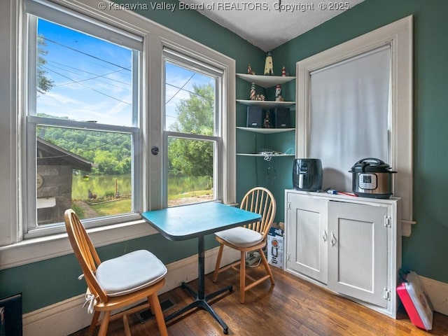 dining area featuring hardwood / wood-style flooring and a healthy amount of sunlight