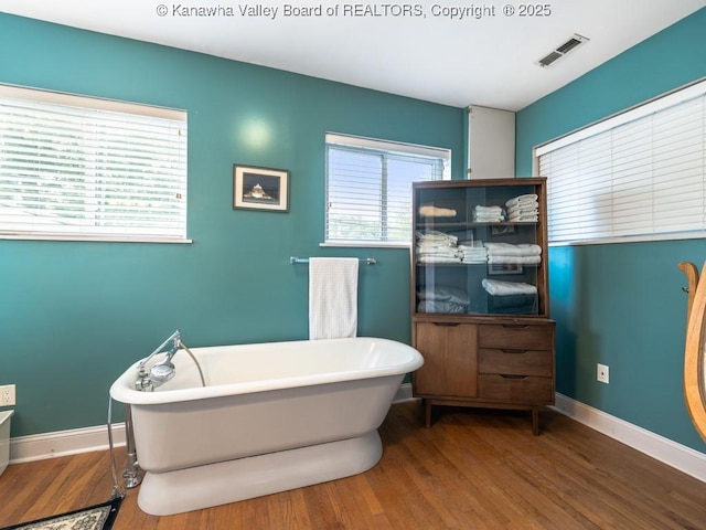 bathroom featuring a bathing tub and wood-type flooring