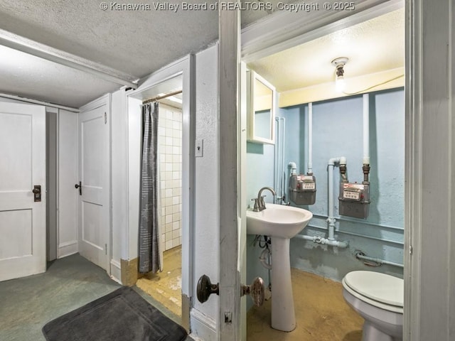 bathroom featuring sink, concrete flooring, a textured ceiling, and toilet