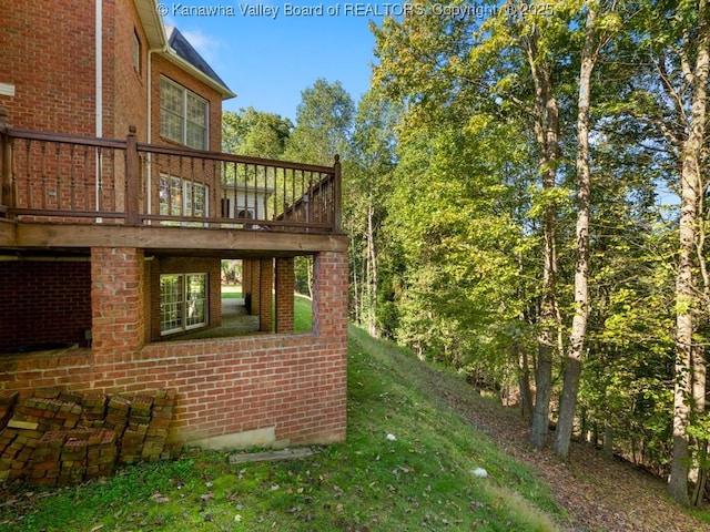 view of home's exterior featuring a deck and a lawn