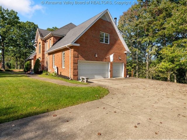 view of side of property with a lawn and a garage