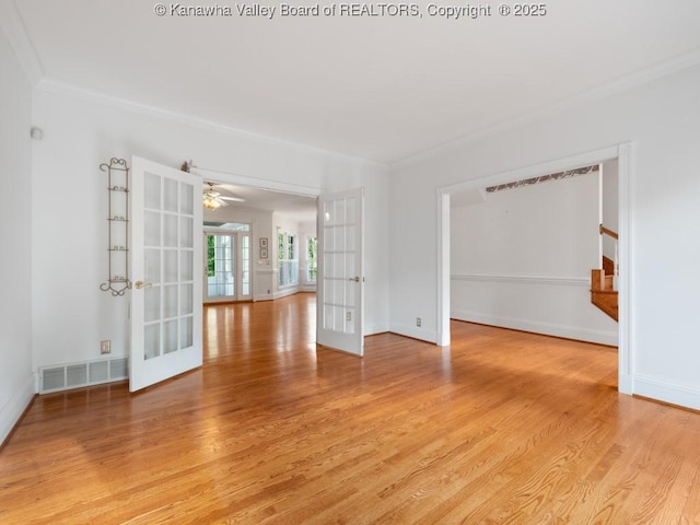 unfurnished room with ceiling fan, french doors, ornamental molding, and light hardwood / wood-style flooring