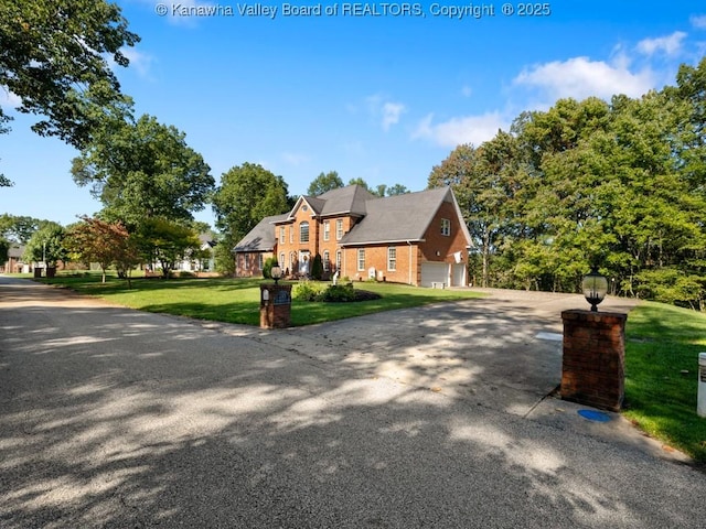 front of property with a front yard and a garage