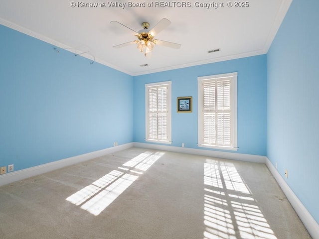 carpeted empty room with ceiling fan and ornamental molding