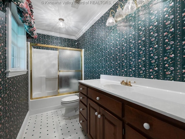 full bathroom featuring vanity, toilet, crown molding, and bath / shower combo with glass door