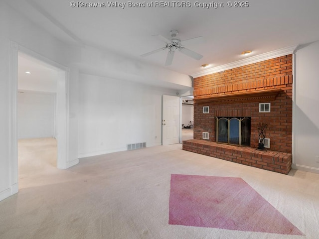 unfurnished living room featuring carpet flooring, ceiling fan, and a brick fireplace