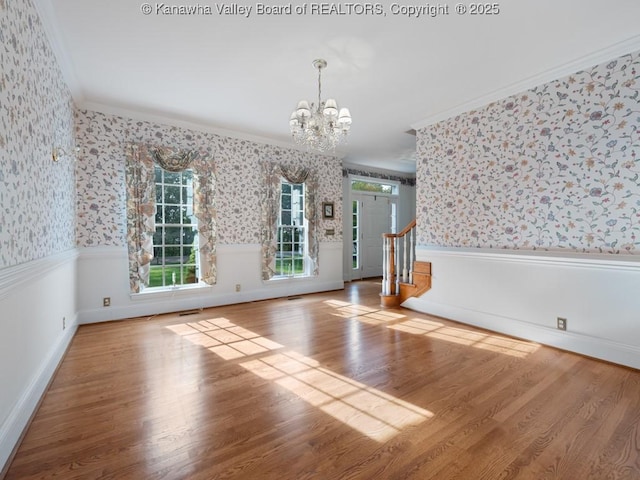 spare room with hardwood / wood-style flooring, ornamental molding, and a wealth of natural light