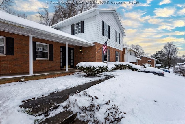 view of snow covered exterior with a porch