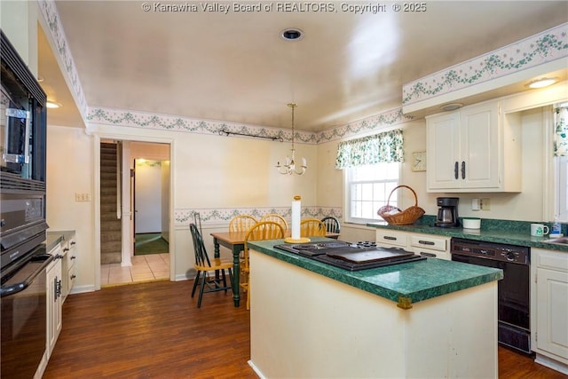 kitchen with dishwasher, a center island, white cabinets, hanging light fixtures, and wall oven