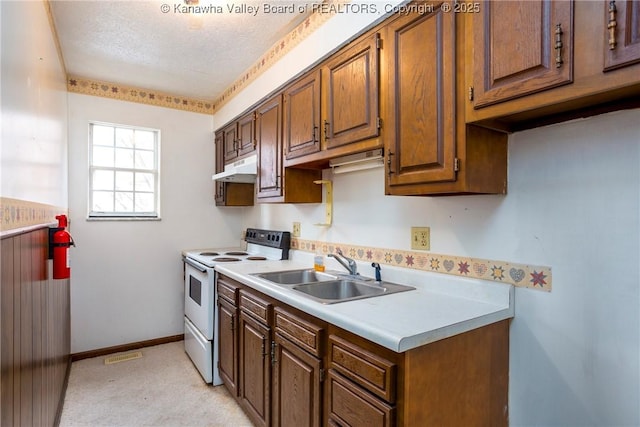 kitchen featuring white electric range, a textured ceiling, and sink