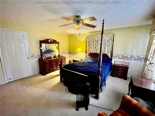 bedroom featuring light colored carpet and ceiling fan