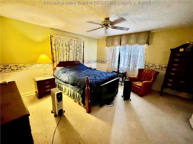 bedroom with ceiling fan and a textured ceiling