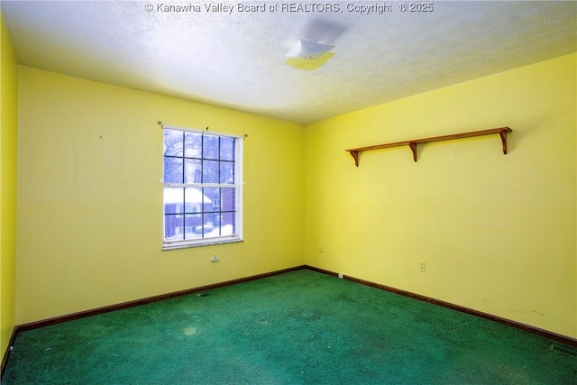 carpeted spare room with a textured ceiling