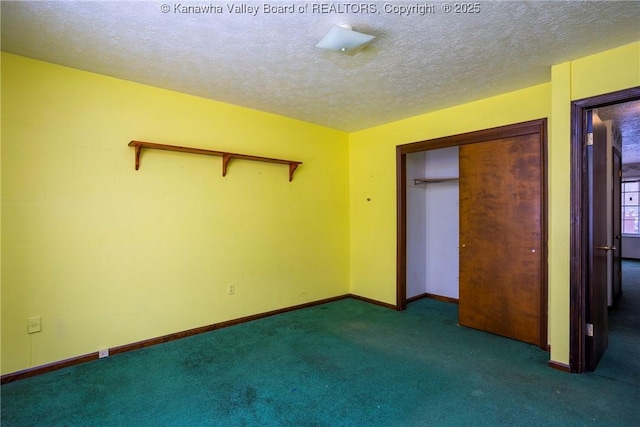 unfurnished bedroom featuring dark carpet, a textured ceiling, and a closet