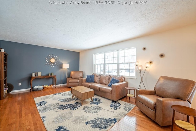 living room with hardwood / wood-style floors and a textured ceiling