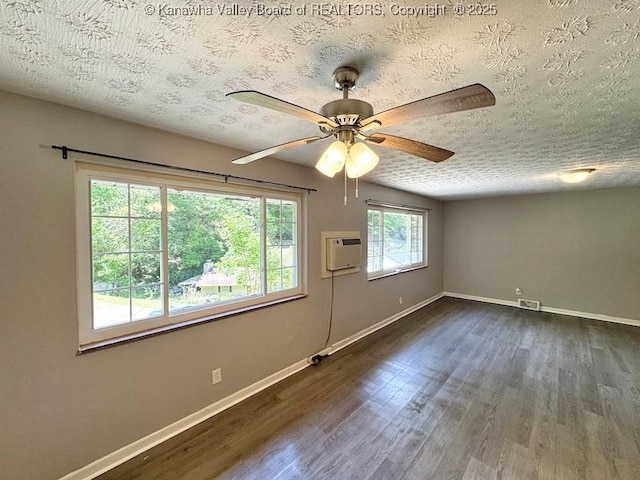 407 S St, South Charleston, WV 25303 - spare room with dark wood-style flooring, a textured ceiling, baseboards, a ceiling fan, and an AC wall unit