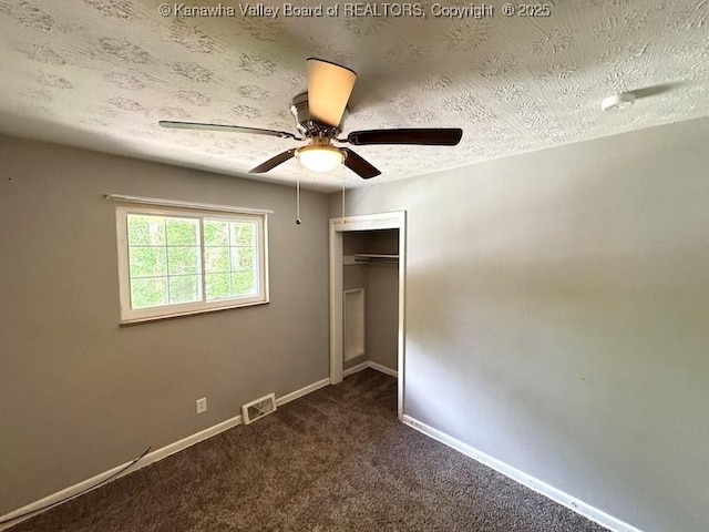 407 S St, South Charleston, WV 25303 - unfurnished bedroom featuring a closet, dark carpet, baseboards, a textured ceiling, and a ceiling fan