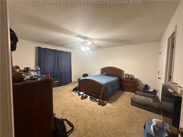 carpeted bedroom with a textured ceiling and ceiling fan