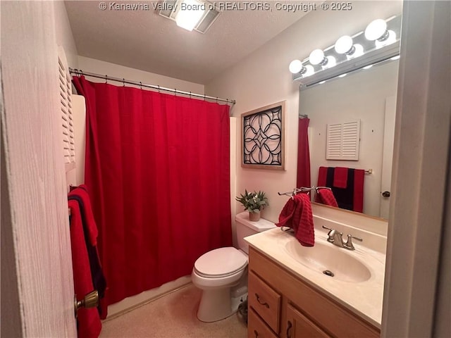 bathroom with vanity, a textured ceiling, and toilet