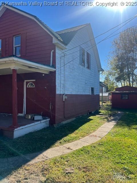 view of side of property with a yard