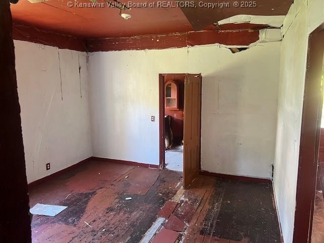 empty room featuring dark wood-type flooring