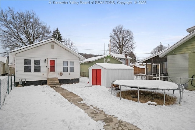 exterior space with a storage shed and a trampoline