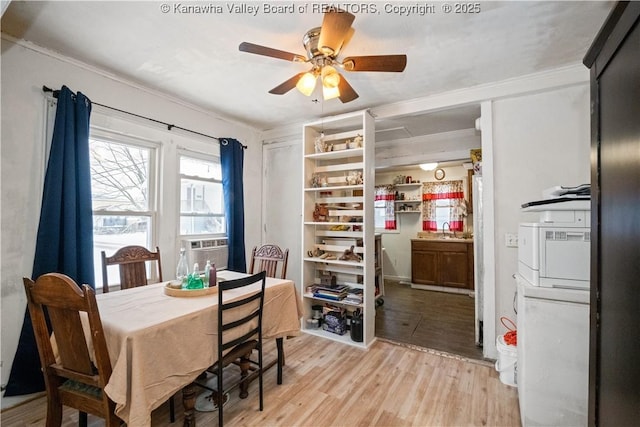 dining space featuring ceiling fan, light hardwood / wood-style floors, sink, and crown molding