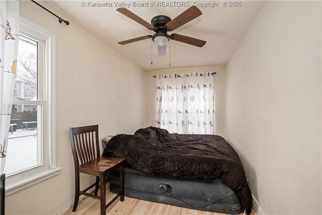 bedroom with ceiling fan and light hardwood / wood-style floors