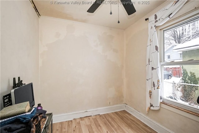 living area with light wood-type flooring and ornamental molding