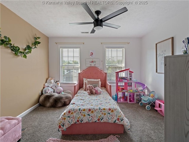 carpeted bedroom with a textured ceiling and ceiling fan