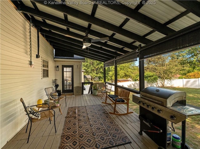 sunroom / solarium with ceiling fan and vaulted ceiling