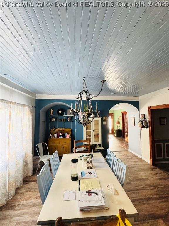 dining space featuring a chandelier, wood ceiling, and hardwood / wood-style floors