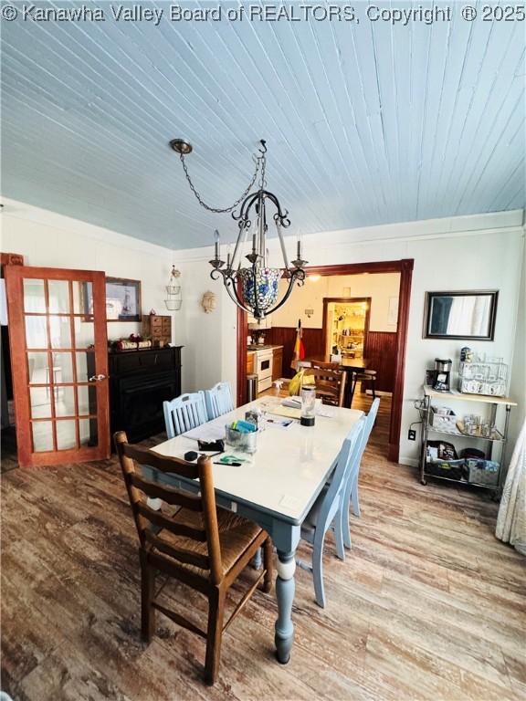 dining area with wooden ceiling, a chandelier, and wood-type flooring