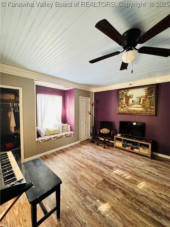 living room with ceiling fan, hardwood / wood-style floors, and crown molding